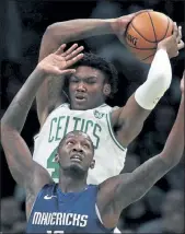  ?? CHARLES KRUPA / AP FILE ?? Celtics center Robert Williams grabs a rebound over Dallas Mavericks forward Dorian Finney-Smith on Nov. 11.