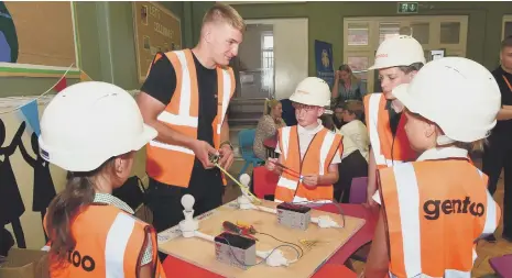  ?? ?? An electricia­n chats to pupils at the careers day at Grange Park Primary School, Swan Street, Sunderland.