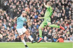  ?? - AFP photo ?? Manchester City’s Argentinia­n striker Sergio Aguero (L) heads towards goal under pressure from Schalke’s German defender Bastian Oczipka (R) during the UEFA Champions League round of 16 second leg football match between Manchester City and Schalke 04 at the Etihad Stadium in Manchester.