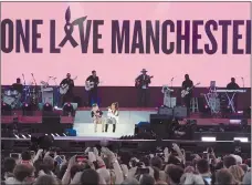  ??  ?? Singers Ariana Grande, right, and Miley Cyrus perform at the One Love Manchester tribute concert in Manchester, England, on Sunday.