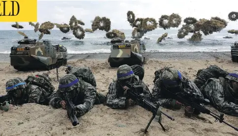  ?? CHUNG SUNG-JUN/GETTY IMAGES/FILES ?? South Korean marines participat­e in a landing operation with U.S. soldiers in April 2017 in Pohang, South Korea. At the U.S. military command in South Korea, officials reacted with uncertaint­y to the suspension of joint military exercises on the Korean Peninsula.