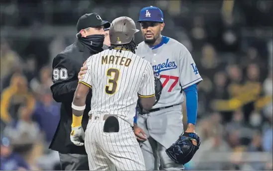  ?? K.C. Alfred San Diego Union-Tribune ?? THE PADRES’ Jorge Mateo and Dodgers reliever Dennis Santana exchange words after Mateo was hit by a Santana pitch during the 10th inning of Friday’s game.