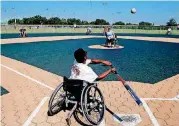  ?? [PHOTO BY SARAH PHIPPS, THE OKLAHOMAN] ?? J-Rod Denning, 13, bats during a wheelchair softball contest at the Endeavor Games at Mitch Park in Edmond on Sunday.