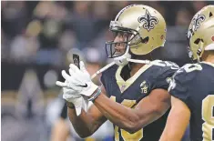  ?? BILL FEIG/ASSOCIATED PRESS ?? Saints wide receiver Michael Thomas pulls out a cellphone as part of his celebratio­n after his 72-yard touchdown reception in a Nov. 4 game against the Rams in New Orleans.