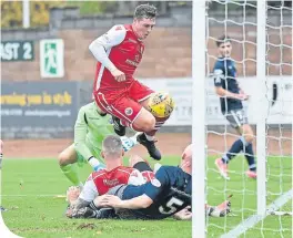  ??  ?? No. 5 Gerry Mclaughlan (grounded) scores Queen’s Park’s second goal against Stirling Albion