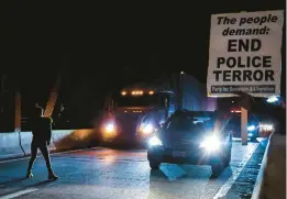  ?? PATRICK LANTRIP/DAILY MEMPHIAN ?? A demonstrat­or tries to stop traffic along a bridge Friday in Memphis, Tenn., during a protest over the death of Tyre Nichols by city police.