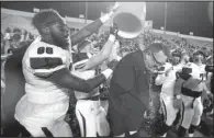  ?? NWA Democrat-Gazette/MICHAEL WOODS ?? Fayettevil­le Coach Bill Blankenshi­p is doused by players after winning the Class 7A state title in his first season with the Bulldogs.