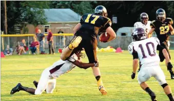  ?? BEN MADRID ENTERPRISE-LEADER ?? Dylan Soehner, shown trying to ward off a defender after making a catch against Morrilton last season, is projected to line up at tight end but could play quarterbac­k where he started in junior high as a freshman.