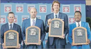  ?? AP PHOTO ?? Newly-inducted National Baseball Hall of Famers, from left, Craig Biggio, John Smoltz, Randy Johnson and Pedro Martinez hold their plaques after an induction ceremony at the Clark Sports Center on Sunday.