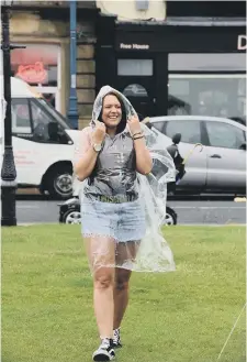  ??  ?? Event co-organiser Laura Ward dresses for Saturday’s wet weather.