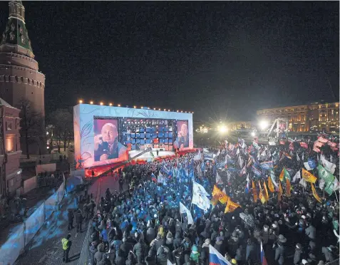  ??  ?? WORKING THE CROWD: President Putin speaks during a concert celebratin­g the fourth anniversar­y of the annexation of the Crimea at Manezhnaya Square, Moscow, March 18.