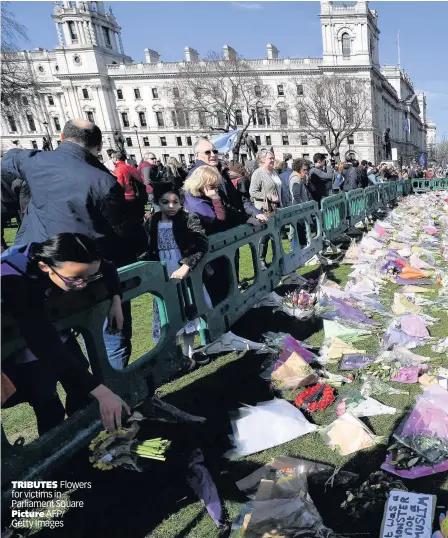  ??  ?? TRIBUTES Flowers for victims in Parliament Square Picture AFP/ Getty Images