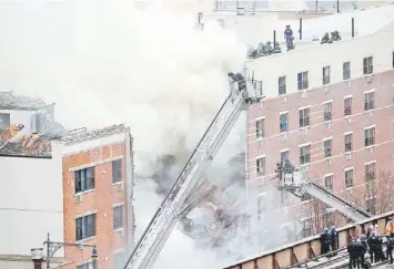  ??  ?? Firefighte­rs from the Fire Department of New York (FDNY) respond to a fire-alarm fire and building collapse at 1646 Park Ave in the Harlem neighbourh­ood of Manhattan in New York City. — AFP photo