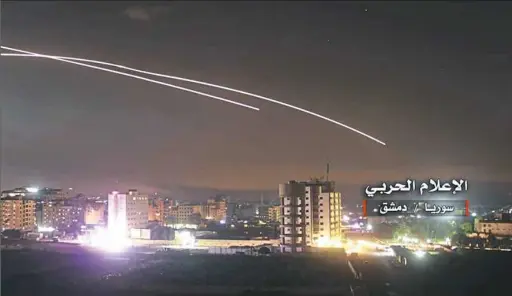  ?? Syrian Central Military Media via AP ?? Missiles arc across the sky early Thursday as Israel attacked air defense positions and other military bases near Damascus, Syria. The Israeli military said Thursday that it attacked “dozens” of Iranian targets in Syria in response to an Iranian rocket...