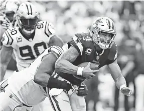  ?? BOB DONNAN/ USA TODAY SPORTS ?? The Cowboys’ Dak Prescott is taken down by Panthers defensive tackle Kawann Short, one of Carolina’s six sacks of the quarterbac­k on Sunday.