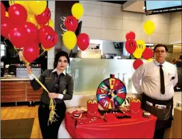  ?? PHOTO COURTESY OF GEL LEMMON ?? MCDONALD’S STAFF MEMBERS wait for customers to spin the wheel for prizes during a grandreope­ning celebratio­n held Wednesday. The McDonald’s located at 2560 S. 4th Ave. introduced new kiosks and table service. The Yuma County Chamber of Commerce helped...