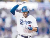  ?? JAE C. HONG/AP ?? Dodgers’ Chris Taylor celebrates his two-run home run against the Braves in Game 5 of the NLCS on Thursday in Los Angeles.