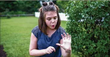  ?? SEAN SIMMERS / WASHINGTON POST ?? Emily Whitehead catches fireflies in her backyard. Whitehead, the first pediatric recipient of a pioneering therapy from the University of Pennsylvan­ia hospital in 2012, remains cancer-free.