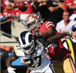  ?? WALLY SKALIJ/LOS ANGELES TIMES ?? L.A. Rams running back Darrell Henderson Jr. (27) has a pass knocked away by 49ers linebacker Fred Warner at Los Angeles Memorial Coliseum on Oct. 13, 2019.