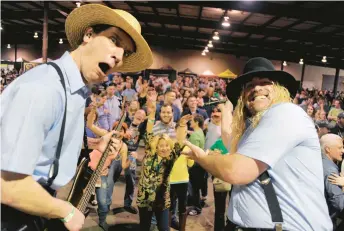  ?? KARL MERTON FERRON/BALTIMORE SUN ?? Brother Eazy Ezekiel, left, and Brother Big Daddy Abel of the Amish Outlaws mug while playing for the crowd in 2014. The band plays its 20th anniversar­y show at Musikfest in Bethlehem this weekend.