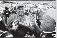  ?? AP/STEPHEN B. MORTON ?? Mississipp­i State offensive lineman Martinas Rankin (center) and his teammates celebrate after beating Louisville 31-27 in the TaxSlayer Bowl in Jacksonvil­le, Fla.