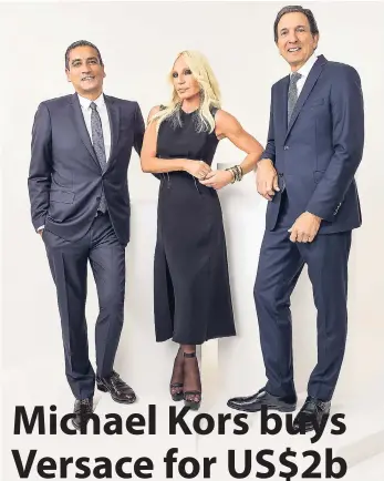  ??  ?? This undated photo provided by Michael Kors shows (from left) CEO of Versace Jonathan Akeroyd, Donatella Versace, and chairman and CEO of Michael Kors John D. Idol.