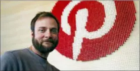  ?? AP PHOTO/BEN MARGOT ?? Pinterest co-founder and chief product officer, poses for a photo stands beside a wall of pegs symbolizin­g the company logo at Pinterest headquarte­rs in San Francisco.