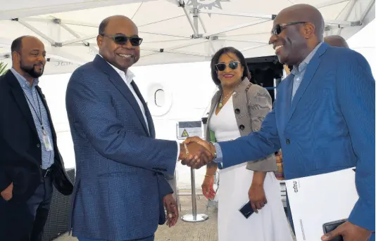  ??  ?? Minister of Tourism Edmund Bartlett is met by Evroy Johnson, group financial controller at Lannaman and Morris group, as he arrives for a tour of the MSC Meraviglia at the Ocho Rios Cruise Ship Pier. Observing the exchange are Michael Belnavis (left), chairman of the National Cruise Council and mayor of St Ann’s Bay and Joy Roberts executive director of Jamaica Vacations.