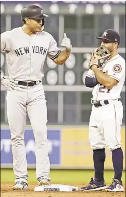  ?? AP ?? You see one tall guy and one very short one, but we see a pair of MVPs in Giancarlo Stanton and Jose Altuve, who ‘face off’ for Yanks and Astros.