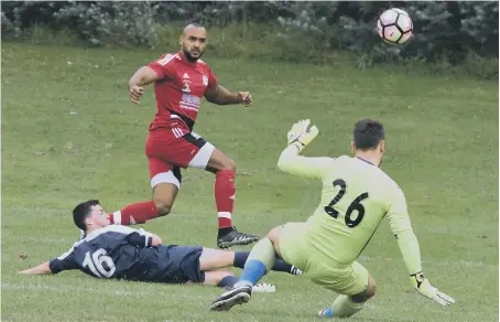  ??  ?? Southwick’s Ash Davis (red) gets in a shot in last week’s clash with Sunderland Sunday League rivals Railway Club. Picture by Kevin Brady