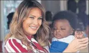  ?? AFP ?? ■ Melania Trump holds a baby in Accra, Ghana, as she embarked on a weeklong tour of Africa, her first solo trip as the US First Lady.