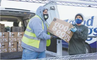  ?? Constanza Hevia H. / Special to The Chronicle ?? Good Eggs delivery drivers Julian Tzic ( left) and Adler Xiloj load boxes with fresh groceries.