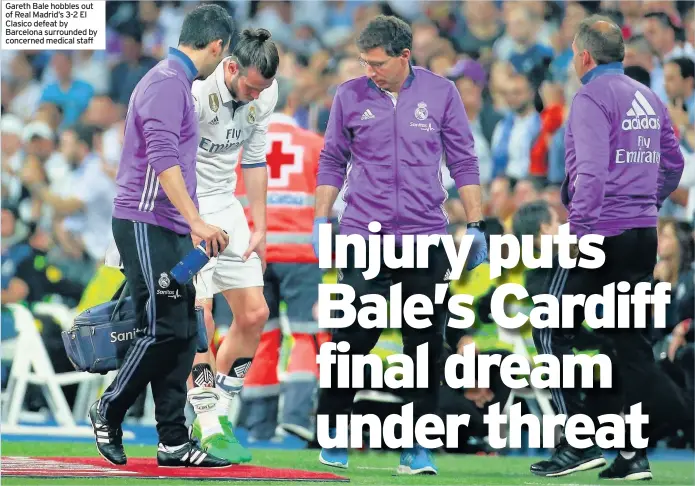  ??  ?? Gareth Bale hobbles out of Real Madrid’s 3-2 El Clasico defeat by Barcelona surrounded by concerned medical staff