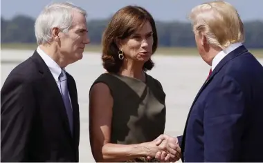  ?? DAYTON DAILY NEWS ?? ‘INCREDIBLE JOB’: President Trump, seen greeting Sen. Rob Portman and his wife, Jane, on arrival Wednesday in Dayton, Ohio, praised first responders there and in El Paso, Texas, top right, for their efforts after last weekend’s mass shootings.