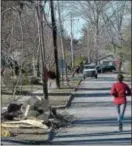  ?? PETE BANNAN — DIGITAL FIRST MEDIA ?? A jogger runs past downed lines along Ellis Road in Havertown.