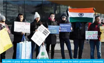  ??  ?? HELSINKI: A group of Indian citizens living in Finland protest against the Indian government’s Citizenshi­p Amendment Act CAA on Sunday. — AFP