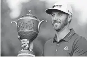  ?? [AP PHOTO] ?? Dustin Johnson poses with his Mexico Championsh­ip trophy at the Chapultepe­c Golf Club in Mexico City on Sunday.