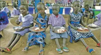  ??  ?? Children enjoy Mary’s Meals at Mazzolari school, South Sudan.