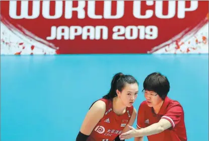  ??  ?? Head coach Lang Ping instructs Zhang Changning during China’s victory over Brazil on Sept 22.