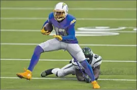  ?? Kyusung Gong Associated Press ?? CHARGERS WIDE RECEIVER Keenan Allen runs away from Jets linebacker Neville Hewitt. Allen f inished with 16 catches for 145 yards and a touchdown.