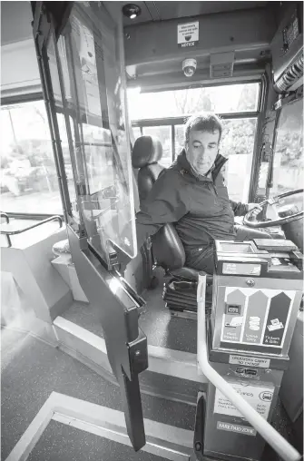  ??  ?? B.C. Transit safety and training officer Sal Ruffolo shows the new bus door that encloses the driver.