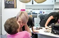  ??  ?? Beryl Paroz gives Intershape Hairstylis­ts hairdresse­r of more than 20 years Cathy Rookas a farewell kiss after her final visit to the Wilsonton salon.