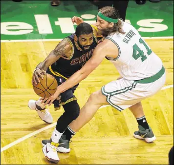  ?? GETTY IMAGES ?? Cavaliers guard Kyrie Irving attempts to drive past Kelly Olynyk of the Celtics during the first half of Game 5. Irving helped Cleveland dominate with 24 points.