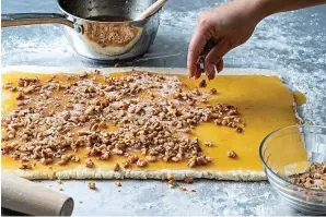  ?? (Photo by Scott Suchman for The Washington Post.) ?? The dough is covered in honey butter and nuts for Baklava Sticky Buns.