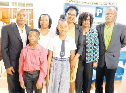  ?? CONTRIBUTE­D ?? Top-performing Primary Exit Profile examinatio­ns boy and girl in Noranda’s operating area in St Ann, Jamari Green and Abrianna Greaves (front), are joined by (from left) Delroy Dell, vice-president and general manager, Noranda Bauxite; Jamari’s mother Christine Green, Abrianna’s mother Normalyn Smith-Greaves, Nordia Tracey, human resource manager, Noranda; and Kent Skyers, community relations superinten­dent, Noranda.