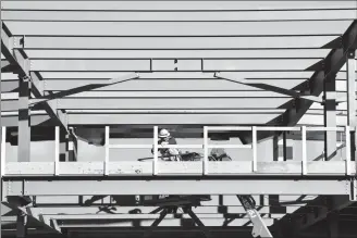  ?? Herald file photo by Ian Martens ?? A worker installs a railing under the bare metal beams of the grandstand recently at Spitz Stadium as the second phase of major renovation­s at the ballpark continue. @IMartensHe­rald