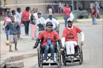  ?? PHOTO: DUMISANI SIBEKO ?? Basetsana Masekoa and Sibusiso Mazibuko during the wheelchair race as part of the disability awareness campaign held in Vosloorus, Ekurhuleni, in this file picture. Preventing discrimina­tion for disabled people is the aim of the NCPD.