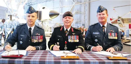  ?? PATRICK DOYLE/THE CANADIAN PRESS ?? Chief of Defence Staff Gen. Jonathan Vance, centre, incoming commander Lt.-Gen. Al Meinzinger, left, and outgoing commander Lt.-Gen. Mike Hood at a scaled-back RCAF change of command ceremony in Ottawa on May 4.