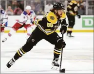  ?? Maddie Meyer / Getty Images ?? The Bruins’ David Pastrnak skates down ice against the Rangers during the first period Saturday.
