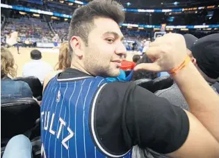  ?? STEPHEN M. DOWELL/ORLANDO SENTINEL ?? Magic fan Armaan Memarpouri sports a Markelle Fultz jersey he purchased minutes before Thursday night's game against the Minnesota Timberwolv­es at Amway Center. Fultz was traded to Orlando on Thursday.